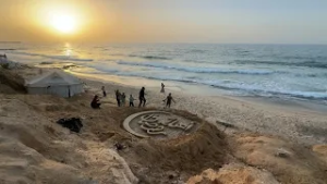 Gazan artist's beach art welcomes start of Ramadan
