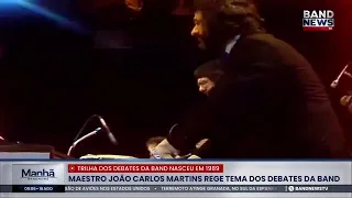 Maestro João Carlos Martins conducts the Band debate theme