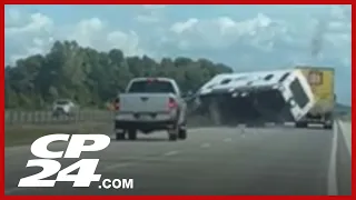 Pickup truck towing camper rolls over on Highway 401