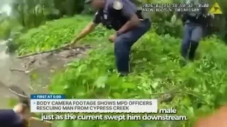 Police pull man to safety from fast-moving creek