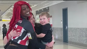 Viral video of TGI Fridays waitress at Atlanta airport helping mother with son raises thousands