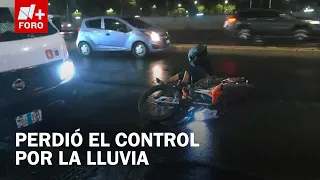 Motorcyclist skids on wet pavement on Zaragoza near La Concordia Bridge