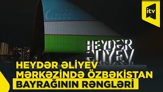 Heydar Aliyev Center building illuminated in the colors of the Uzbekistan flag