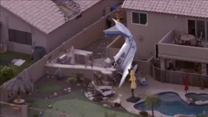 Small plane hits homes in AZ, crashes nose-down next to backyard pool