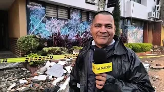 Sheltered from the cold by his ruana, he guards the ruins of the Roldanillo City Hall after the e...