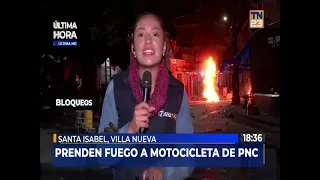 PNC motorcycle set on fire during riots at kilometer 19 in Villa Nueva