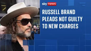 Russell Brand says he feels 'blessed' outside court before pleading not guilty