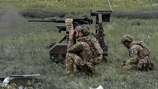 In Warsaw, volunteers assemble drones and anti-drone camouflage nets to help Ukrainians defend th...