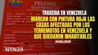 Houses affected by earthquakes in Venezuela marked with red paint as uninhabitable