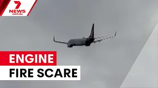 Qantas flight diverted after mid-air engine fire | 7NEWS
