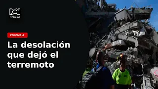 The desolation left by the earthquake: Families recover their belongings from the rubble